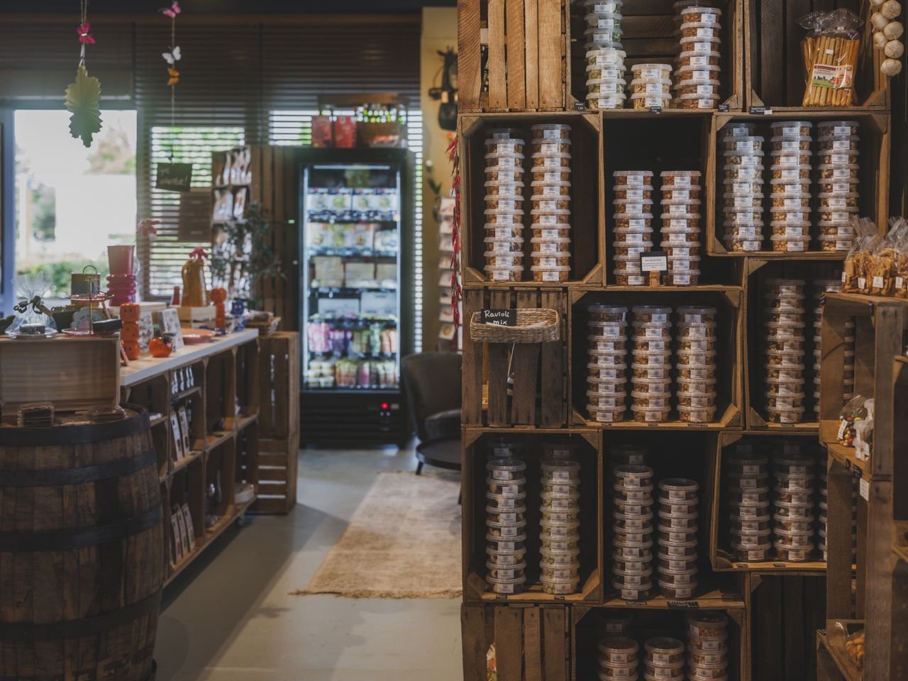 Explore a cozy local store in Almere featuring a variety of packaged nuts and rustic wooden décor.