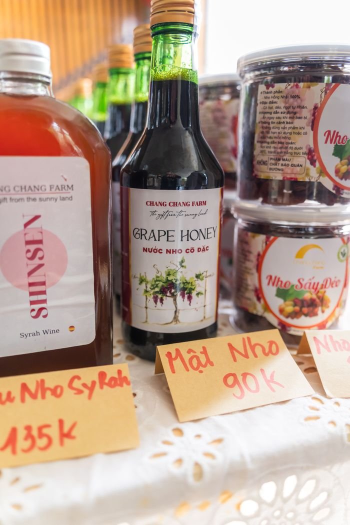 Services Variety of grape products including honey, juice, and preserves on display at a market stall.
